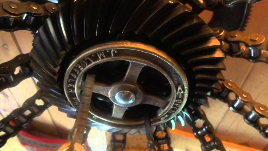 A recycled metal rotating pot rack with a theme of power transmission, made by me as a gift for my wife's birthday.